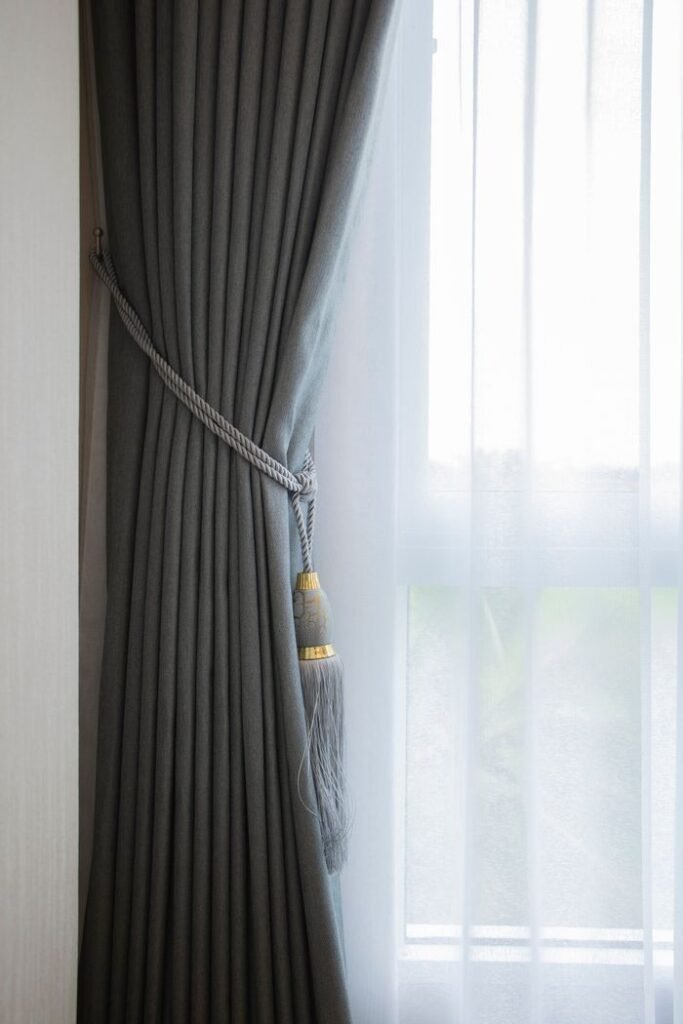 Crafting Captivating Headlines: Your awesome post title goes here Soft gray curtain with decorative tassel tieback complemented by sheer white curtain