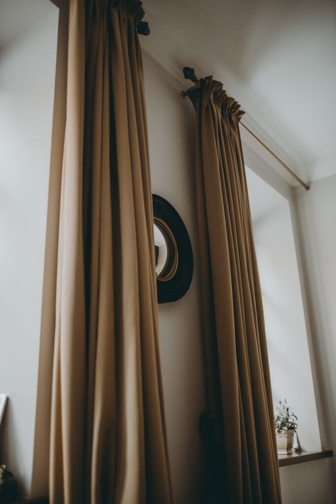 Contemporary apartment interior featuring elegant brown curtains and decor in a minimalist style.