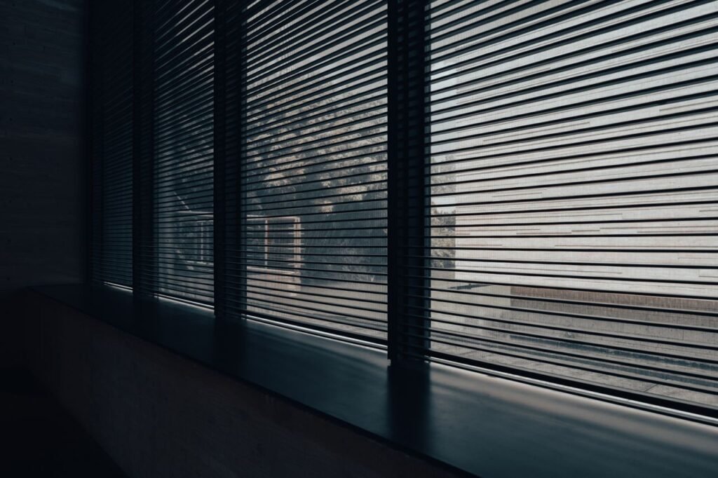 Modern interior space with sleek blinds providing a minimalist aesthetic and diffused natural light.